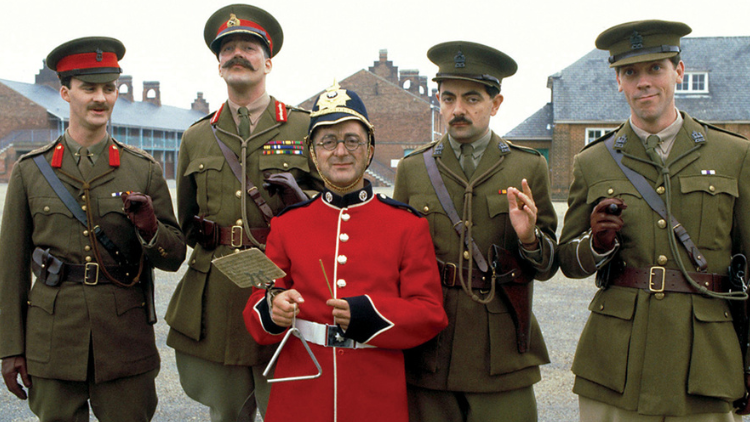 The cast of Blackadder look into the camera, in World War I get-up