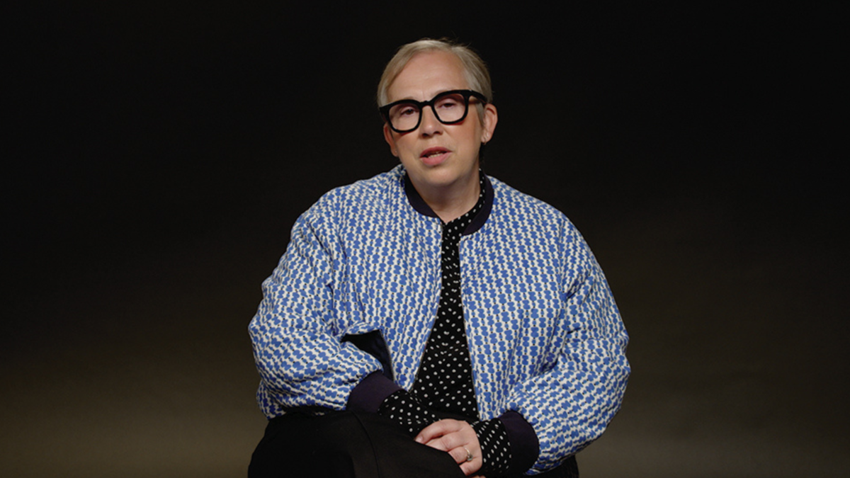 Abi Morgan sits talking in front of a black backdrop