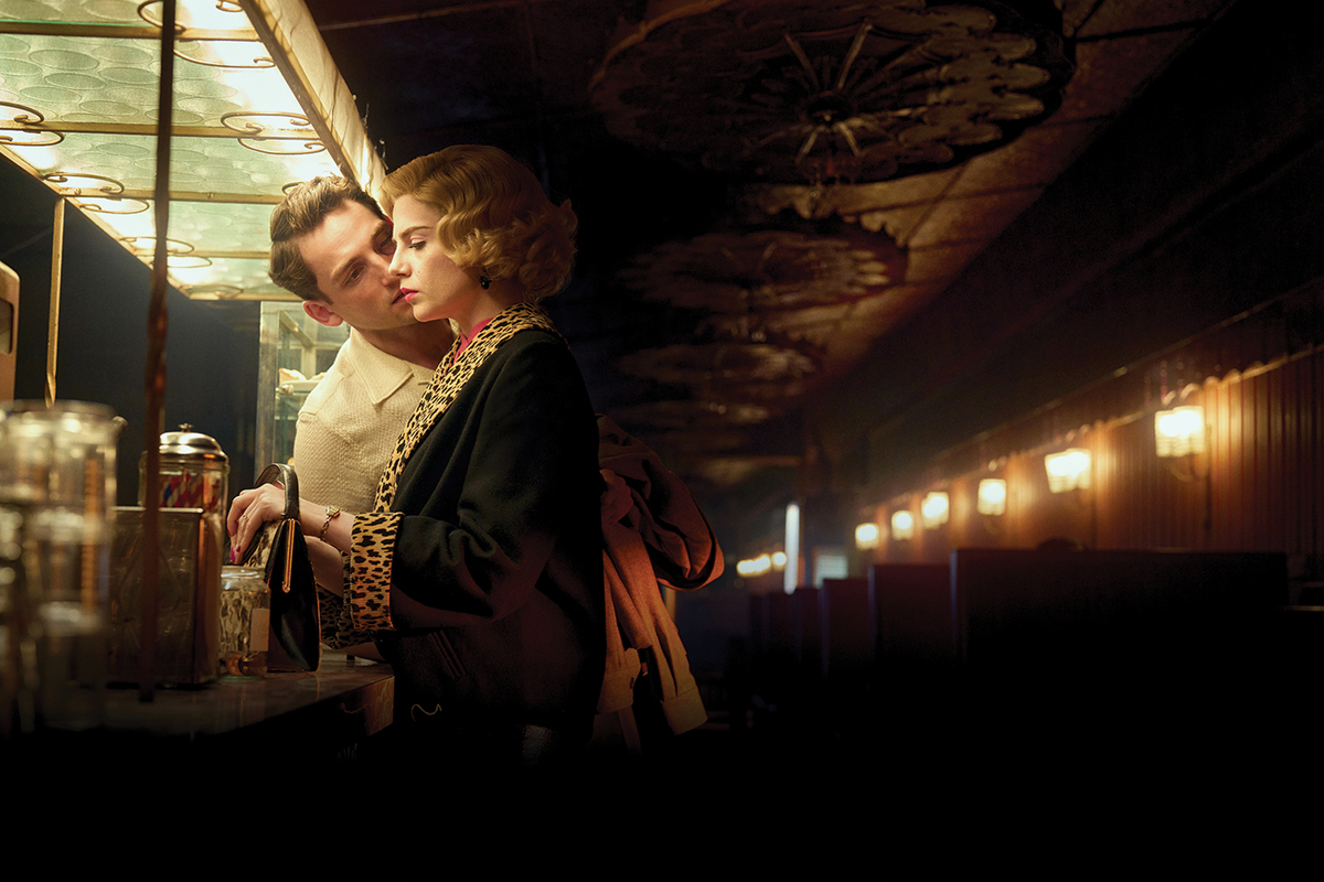 A white couple stand at the bar in an old pub