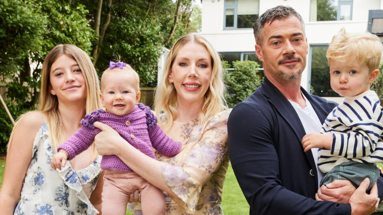 Katherine Ryan and Bobby Kootstra pose with their children outdoors