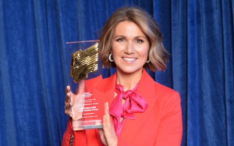 Susanna Reid holds up her award and smiles at the camera at the RTS Television Journalism Awards