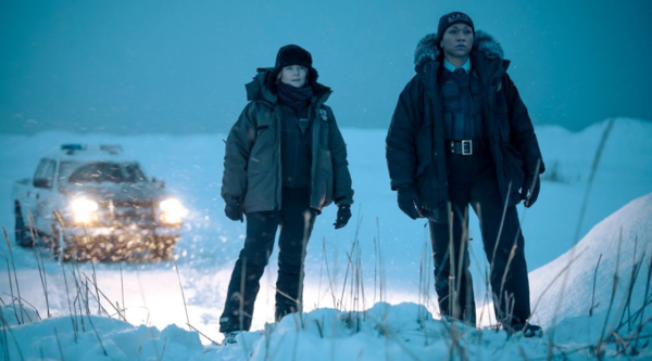 Jodie Foster and Kali Reis stand in a snowy, barren landscape in Alaska, dressed in wintery police uniform, playing detectives in True Detective: Night Country