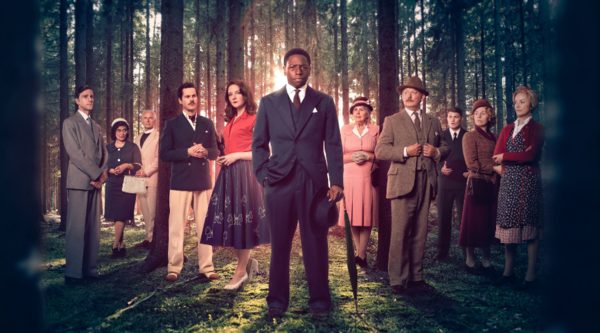 The cast of Murder is Easy stand in a forest