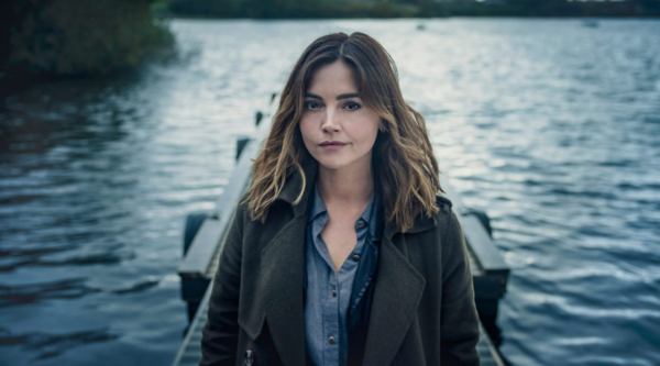 Jenna Coleman, in character as Ember Manning, looks into the camera at the foot of a jetty