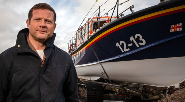 Dermot O'Leary stands in front of an RNLI boat