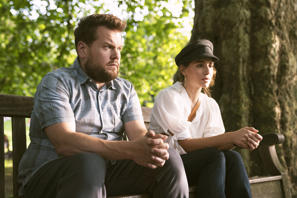 James Corden and Melia Kreiling as Jamie and Amandine sat on park bench in Mammals 