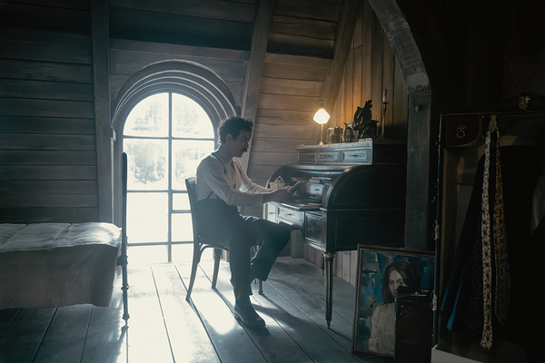Ewan McGregor plays Alexander Rostov, sitting at a writing desk in an attic