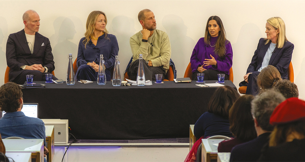 Two men and three women sit in a row on a panel discussion