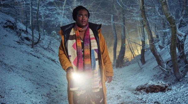 Wunmi Mosaku stands in a frosty woodland with a flashlight in ITV's Passenger
