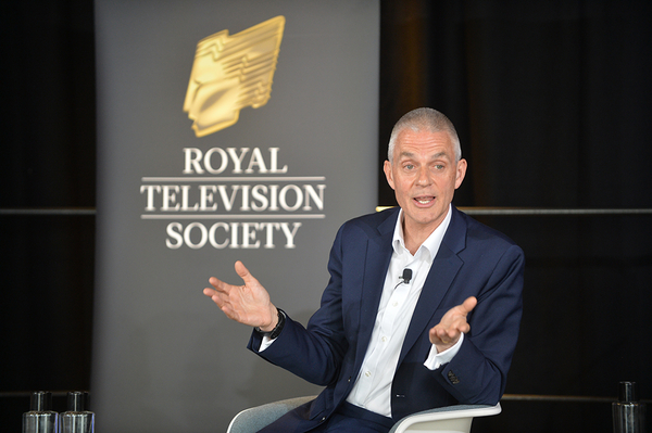 Tim Davie sits in front of a Royal Television Society banner