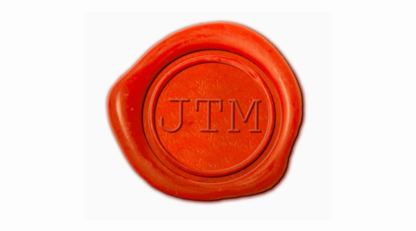 Junior Taskmaster logo. Red wax seal with the letters JTM stamped on it.