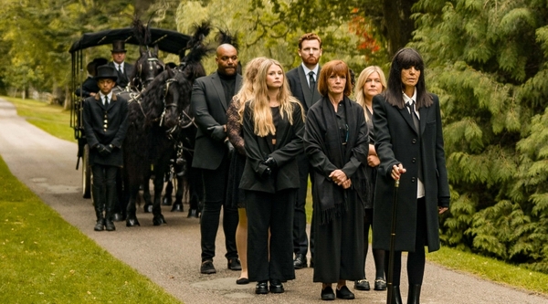 Claudia Winkleman leading the funeral procession in The Traitors