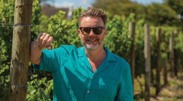 Gary Barlow stood in a vineyard