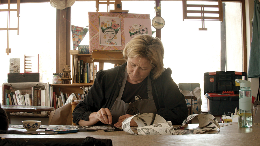 Susan, the subject of the documentary Walking the Labyrinth, sits at a desk drawing