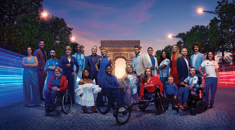 Channel 4’s 2024 Paralympics team in Paris, in front of the Arc de Triomphe and long exposure streaks of red and blue light  