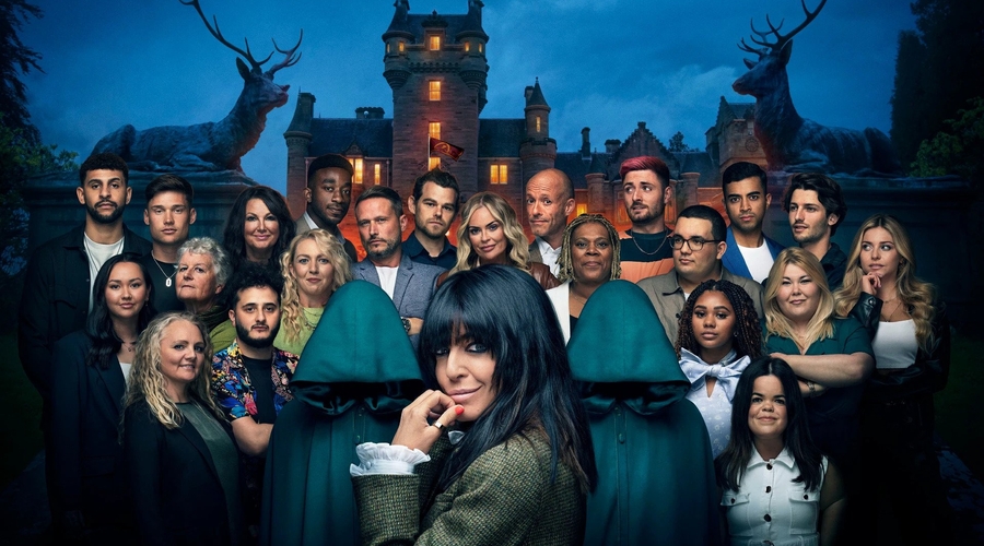 Claudia Winkleman looks at the camera, with series one contestants stood behind her