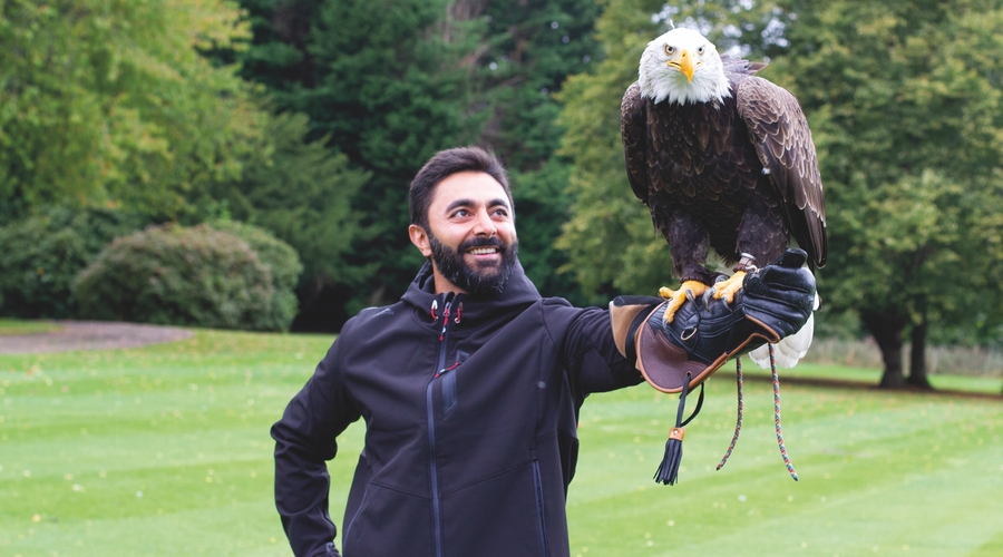 Dr Masood Khodadadi holds a bald eagle