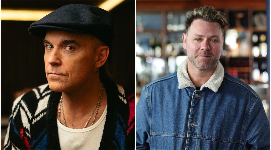 A split screen image shows Robbie Williams on one side, and Brian McFadden on the other. Williams is a male in his 50s with a light to medium skin tone wearing a cardigan patterned with white, black and navy diamonds, and a navy flat cap. McFadden is in h