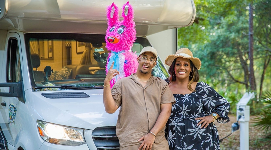 Aidan Hammond and Alison Hammond stand side by side in front of their caravan in Florida