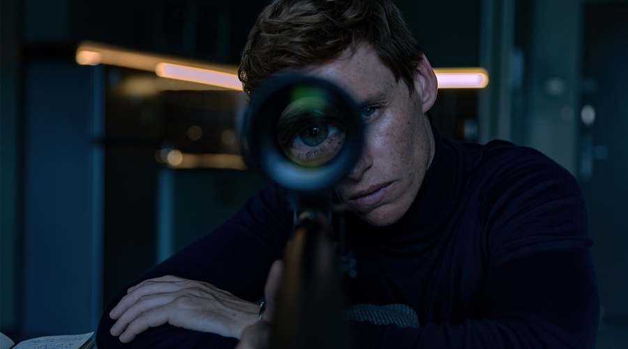 Eddie Redmayne stares down the sight of a sniper as the titular assassin in The Day of the Jackal