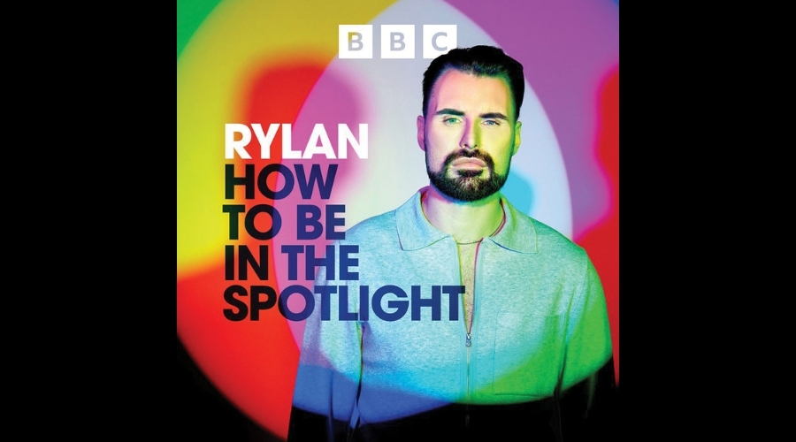 Rylan stands in front of multicoloured lights, the BBC logo above him and text reading "RYLAN: HOW TO BE IN THE SPOTLIGHT" to his left