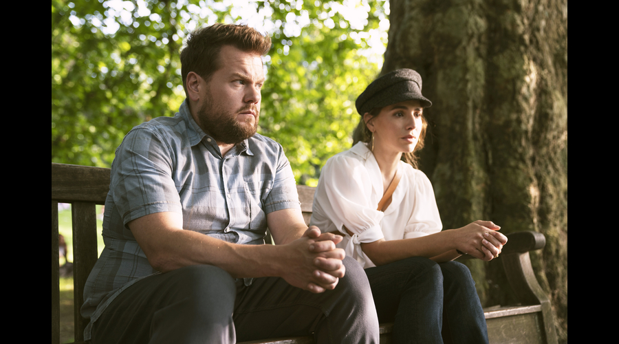 James Corden and Melia Kreiling as Jamie and Amandine sat on park bench in Mammals 