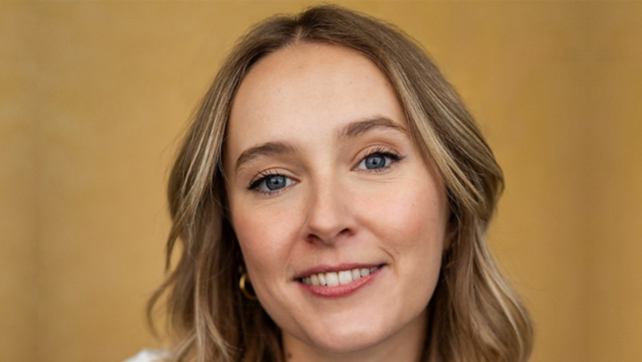 Rose Ayling-Ellis smiles in front of a gold backdrop