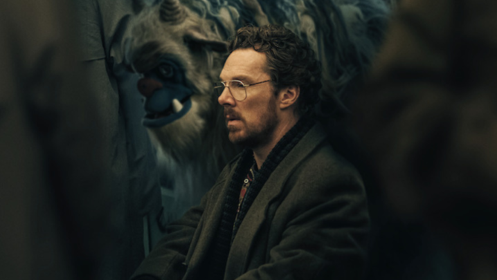 Benedict Cumberbatch sits next to a large, furry monster