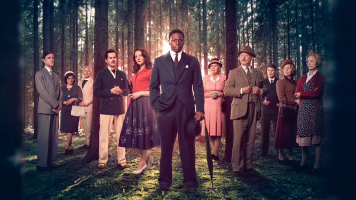 The cast of Murder is Easy stand in a forest