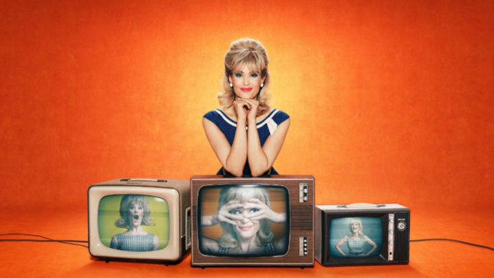 Sophie Straw sits with her arms on top of three TVs from the 1960s, each with a different image of her