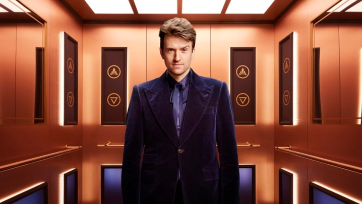 Greg James looks at Camera in a lift 
