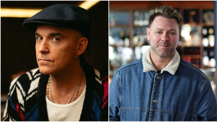 A split screen image shows Robbie Williams on one side, and Brian McFadden on the other. Williams is a male in his 50s with a light to medium skin tone wearing a cardigan patterned with white, black and navy diamonds, and a navy flat cap. McFadden is in h