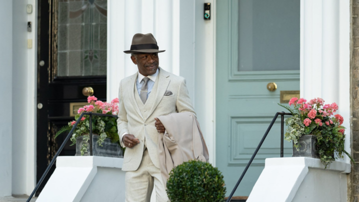 Lennie James as Barrington Walker walks out of his house in a distinctive, lightly-coloured suit