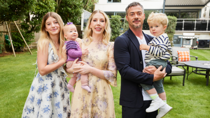 Katherine Ryan and Bobby Kootstra pose in a garden with their three children