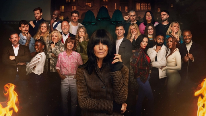 Claudia Winkleman stands in front of the cast of The Traitors series two, who stand in front of a gloomy Scottish castle