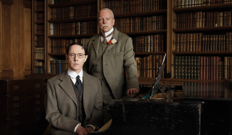 Reece Shearsmith and Steve Pemberton sit in an old library room, both in late 19th century suits