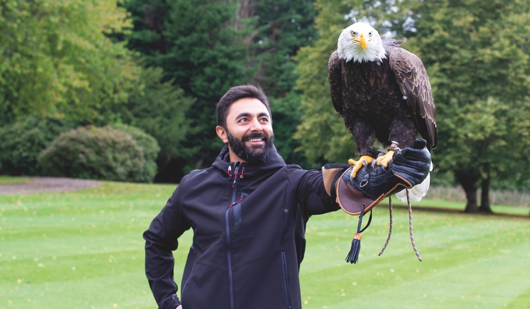 Dr Masood Khodadadi holds a bald eagle
