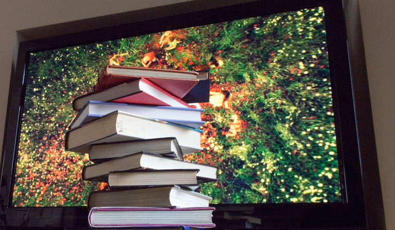 books in front of tv image