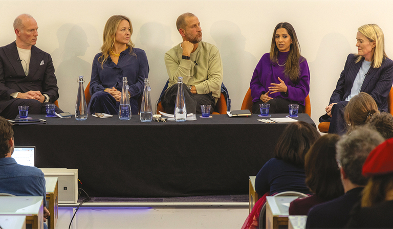 Two men and three women sit in a row on a panel discussion