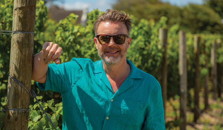 Gary Barlow stood in a vineyard