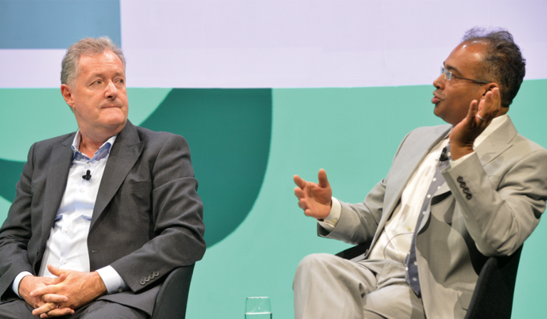 Piers Morgan and Krishnan Guru-Murthy sit next to each other in conversation at the RTS Cambridge Convention 2023